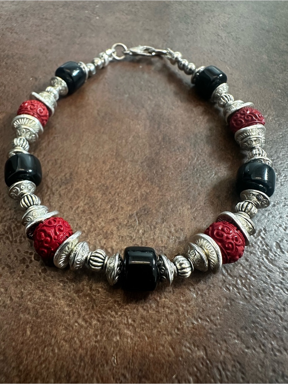 Red and Black Beaded Bracelet with Silver Accents by